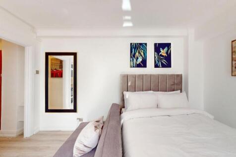 Bright, modern bedroom with a plush upholstered...