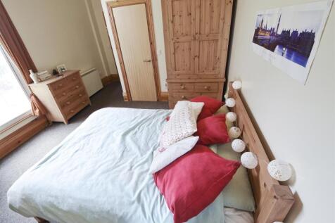 Bright double bedroom with ample storage space ...