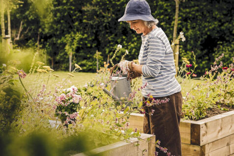 a man holding a bucket of flowers