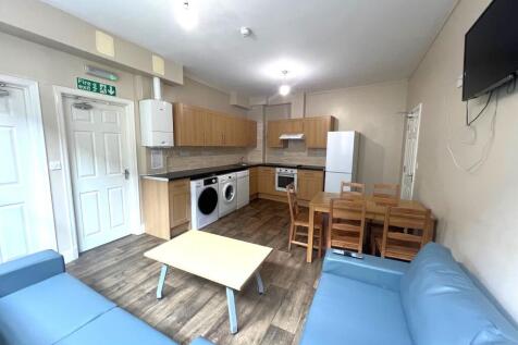 Bright communal lounge with an open-plan kitche...