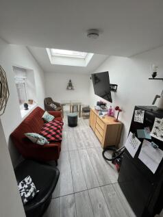 Bright lounge with skylight and modern flooring...