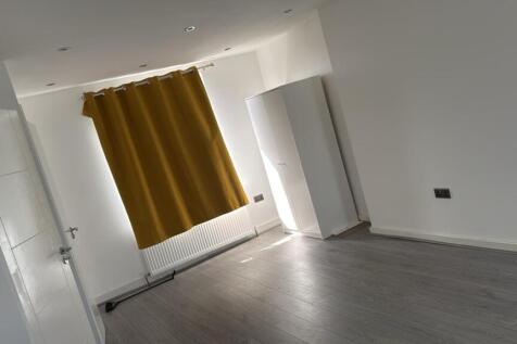 Bright bedroom with sleek wood-style flooring...