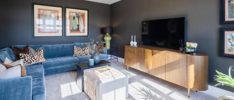 Redrow interior image of separate lounge area with stylish furnishings and dark blue walls