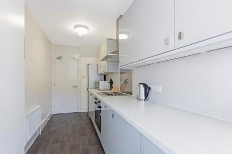 A modern and tidy kitchenette equipped with ess...