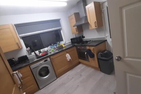 Neat modern kitchen with wood-effect cabinets, ...