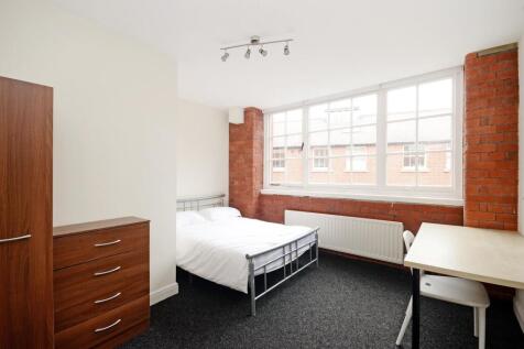 Bright and modern bedroom featuring a large win...