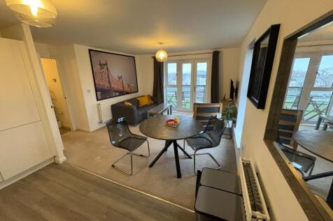 Bright, modern open-plan living area with dinin...