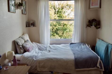 A bright and inviting double bedroom featuring ...