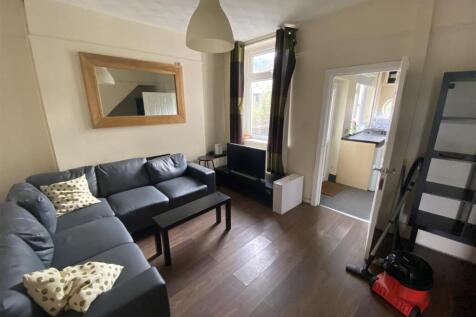 Charming lounge with large sofa and wood floors...