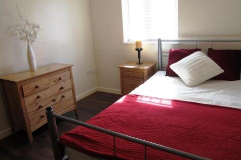 A bright and inviting double bedroom with styli...