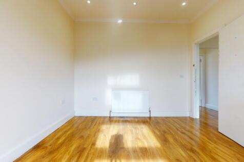 Bright, freshly painted bedroom with polished h...