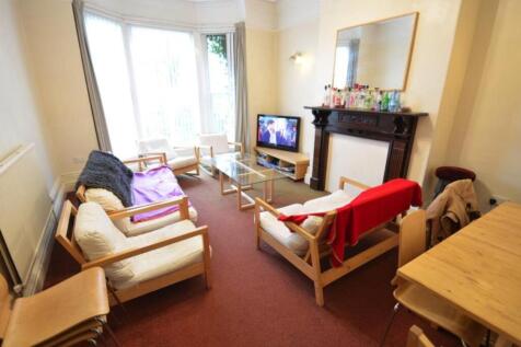 Bright, comfortable living room with a bay wind...