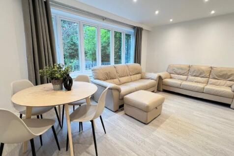 Bright modern lounge with seating and dining ar...