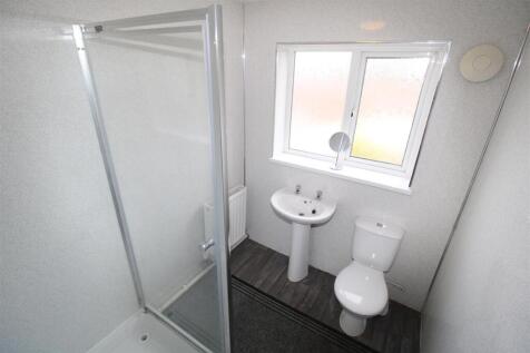 Bright modern shower room with large window...