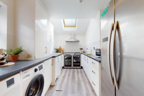 A bright and modern kitchen with ample space an...