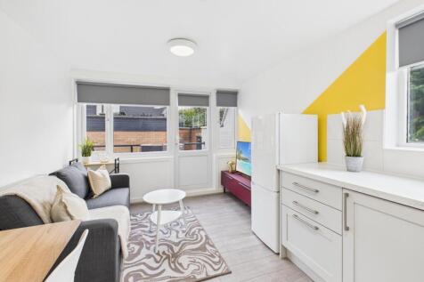 Bright, modern living area with large windows, ...