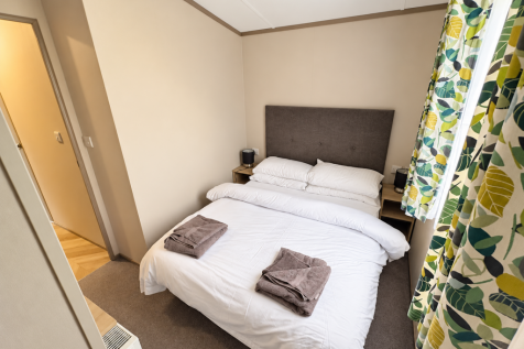 Cosy Double Bedroom With Neutral Decor And Botanic