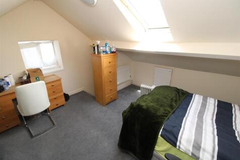 Bright attic bedroom with skylight and study de...