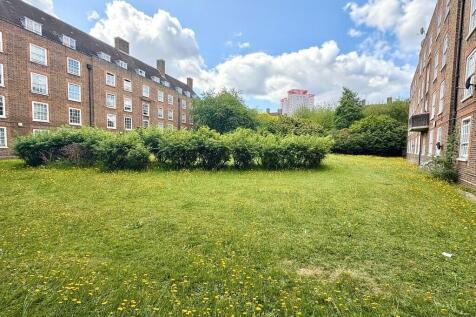 Expansive sunny garden with lush green lawn...