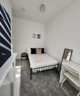 A bright and clean double bedroom featuring a c...