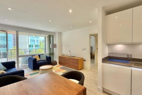 Bright open-plan living space with balcony view...