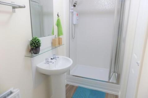 Bright, modern bathroom with a walk-in shower, ...