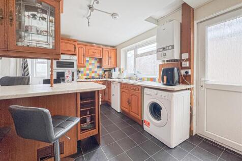 Bright kitchen with breakfast bar and appliance...