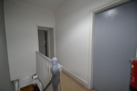 Bright, freshly painted upstairs hallway with a...