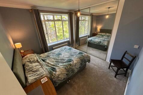 Bright double bedroom with mirrored wardrobes...