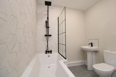 Modern bathroom with chic black shower fixtures...