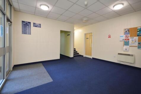 Bright ground-floor entrance lobby with noticew...