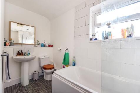 Bright bathroom with bathtub and stylish mirror...
