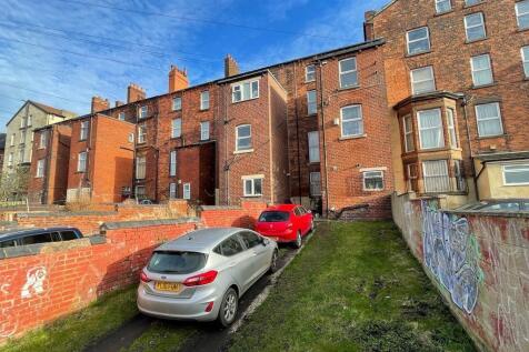 Traditional brick terrace under a bright blue s...