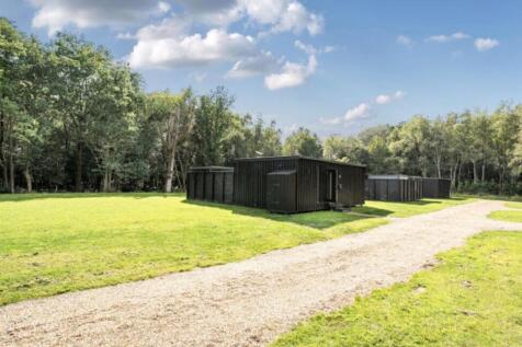 Existing Cabins Against Woodland