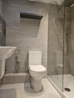 Modern tiled bathroom with sleek glass shower...