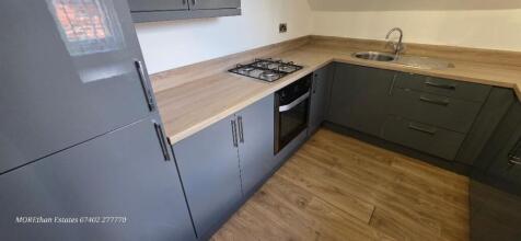 Modern kitchen with stylish grey units and hob...
