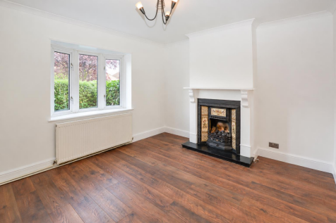 Bright Empty Living Room with Fireplace.png