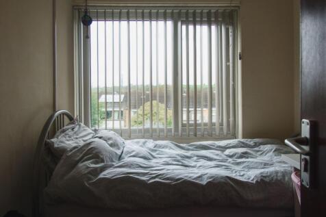 Bright bedroom with large window and scenic vie...