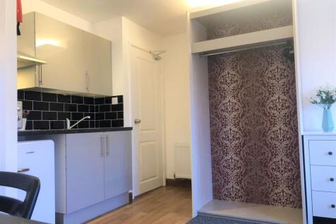 A clean and modern kitchenette featuring sleek ...