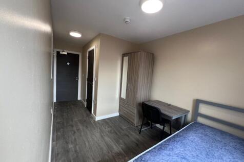 A well-lit, modern bedroom featuring a double b...