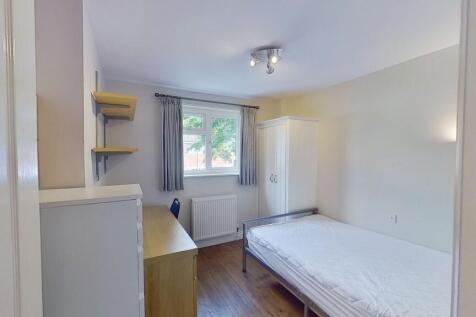 Bright, neatly furnished single bedroom with a ...