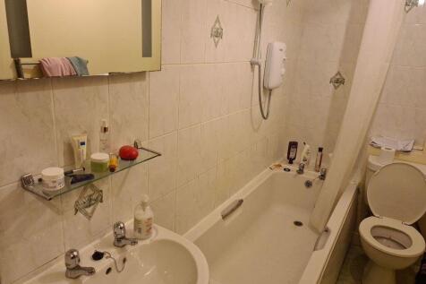 A clean and practical bathroom featuring a bath...
