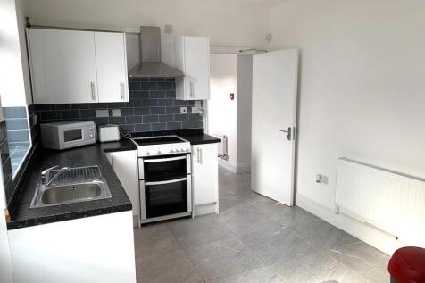 Bright and clean kitchen featuring modern white...