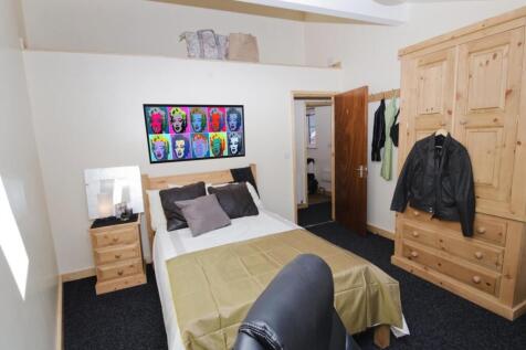 Bright, well-kept bedroom with a comfortable do...