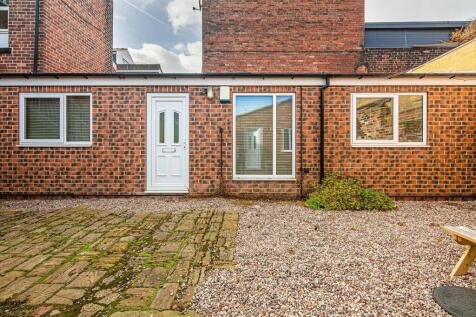 Low-maintenance paved and gravel courtyard outs...