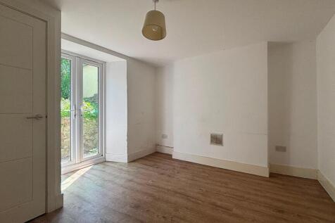 Bright modern room with sleek wood floors...