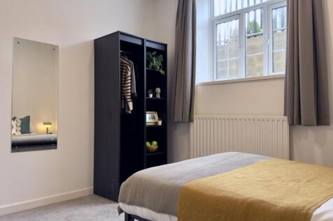 A bright and inviting double bedroom featuring ...