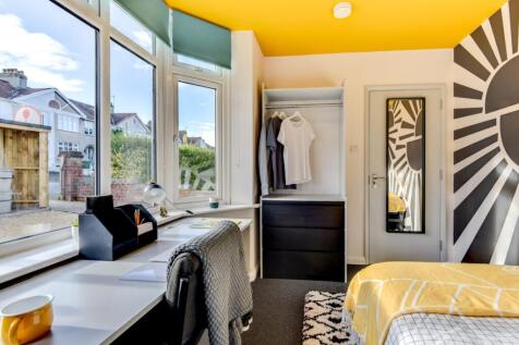 Bright, stylish bedroom with a large bay window...