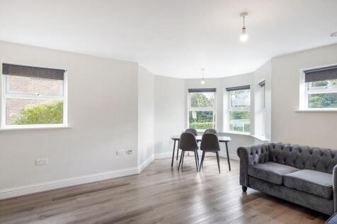 Bright, airy lounge with stylish bay window sea...
