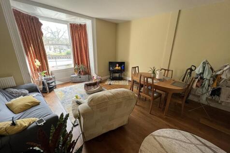 Spacious living room with large bay window...